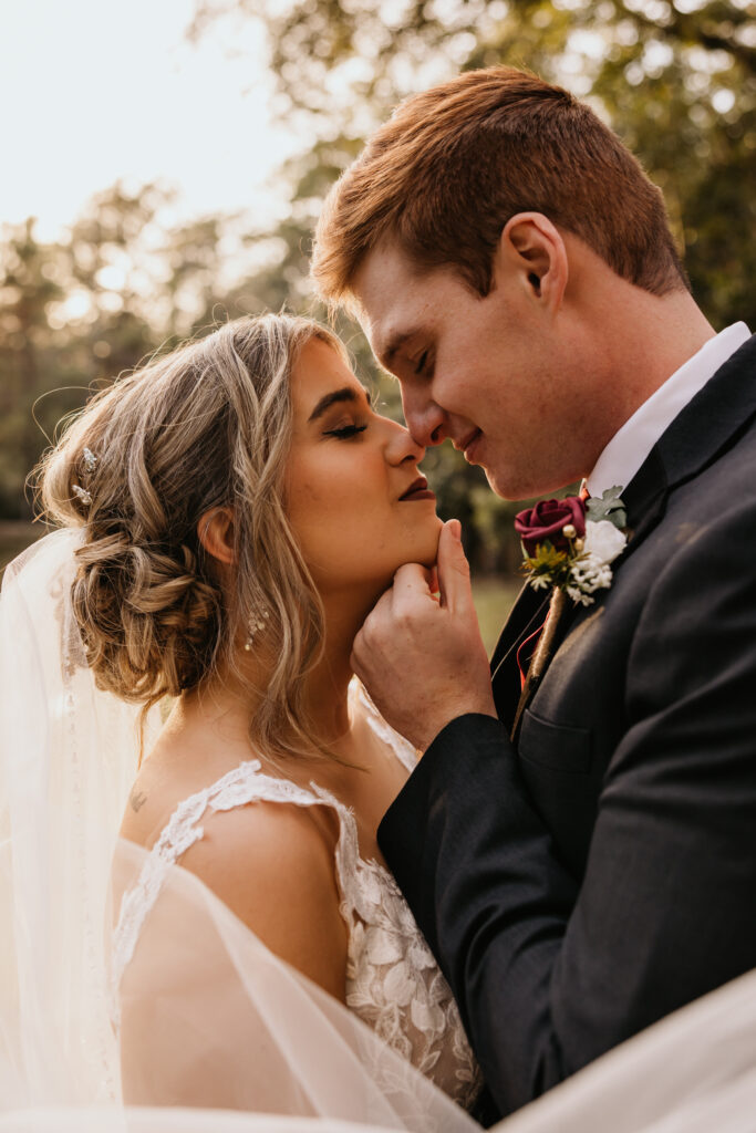 Bella Sera Gardens wedding in Loxley, AL by Higgins Photo and Film. The couple lightly touches noses.