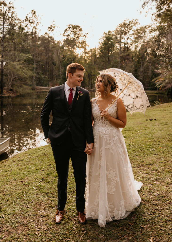 Bella Sera Gardens wedding in Loxley, AL by Higgins Photo and Film. The bride holds a parasol