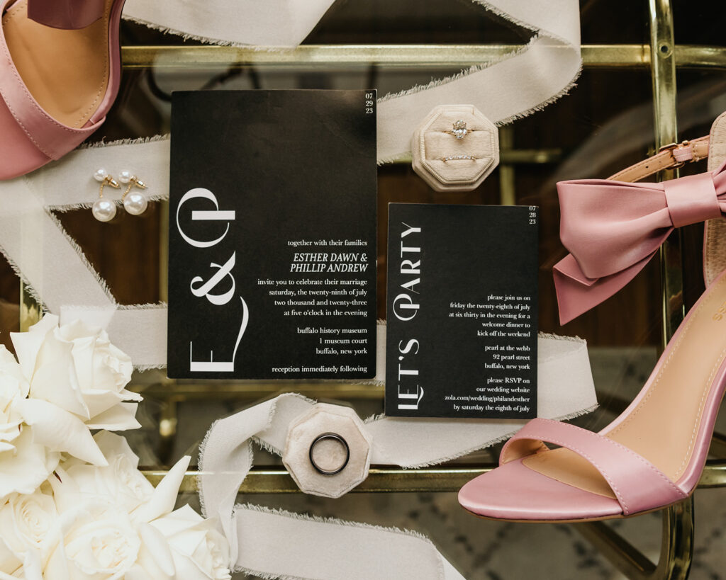 A timeless modern wedding in Upstate New York. Detail image of the wedding invitations, rings, and shoes.