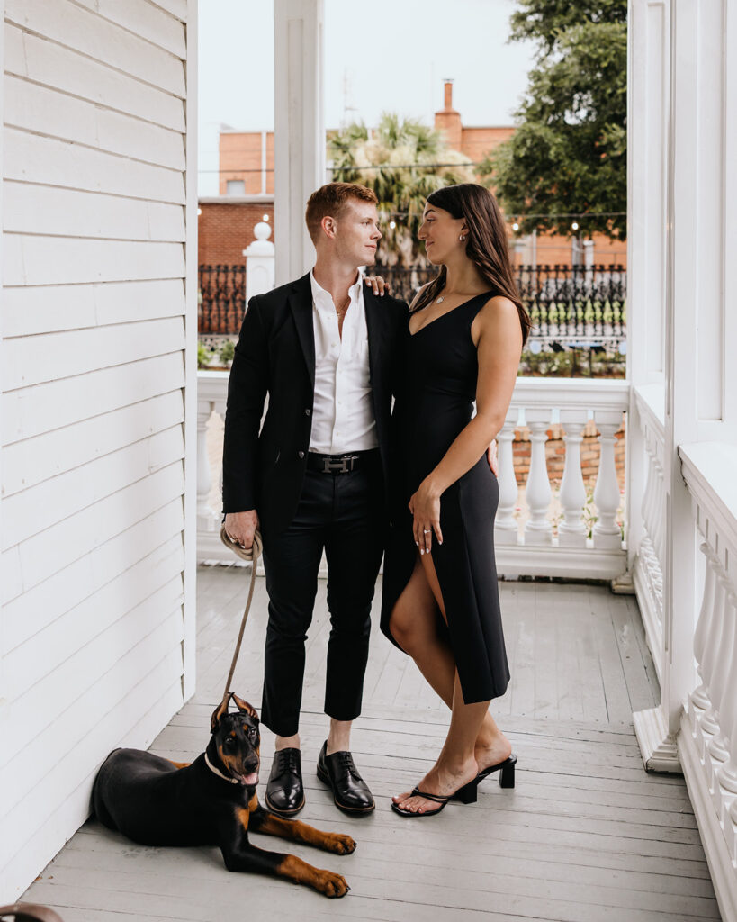 man and woman pose with their dog