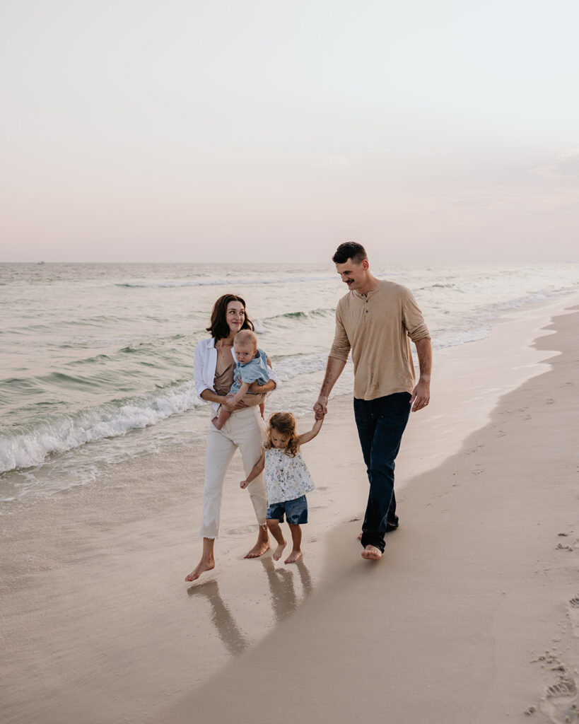 young family walks along the shore of Rosemary beach
