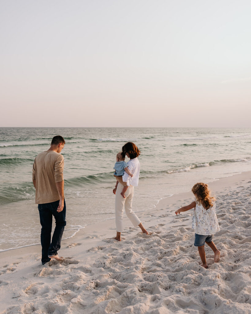 family runs around on the beach