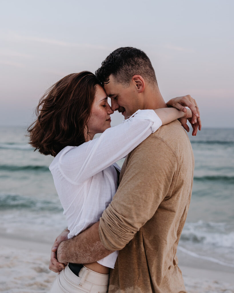man and woman hug on the beach