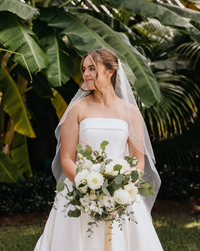 Bride smiles while holding her bouquet