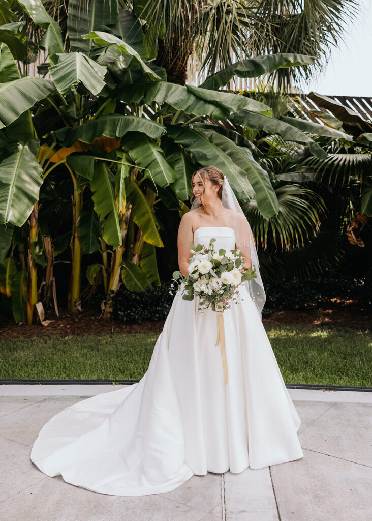 Bride smiles while holding her bouquet
