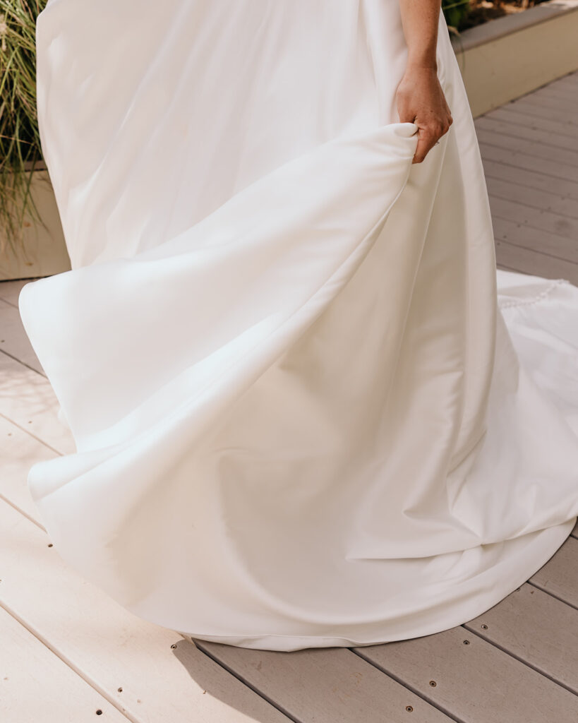 Bride swishes her wedding dress