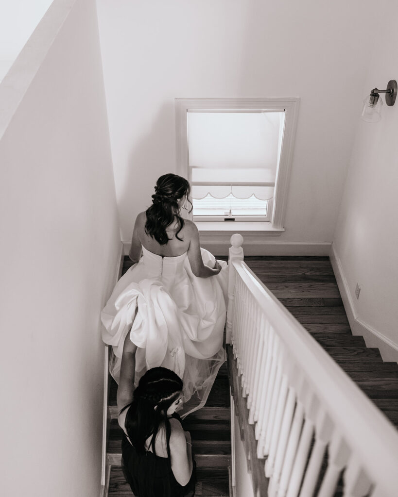 bride and bridesmaid walking up stairs