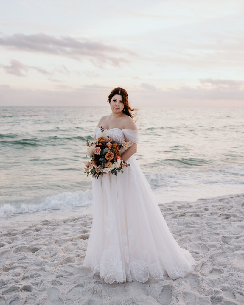 bride stands by the ocean