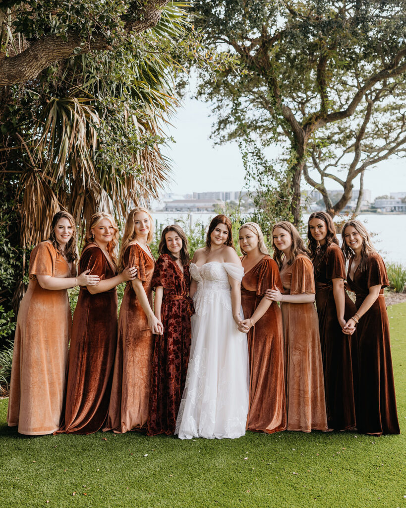 bride and bridesmaids hold hands