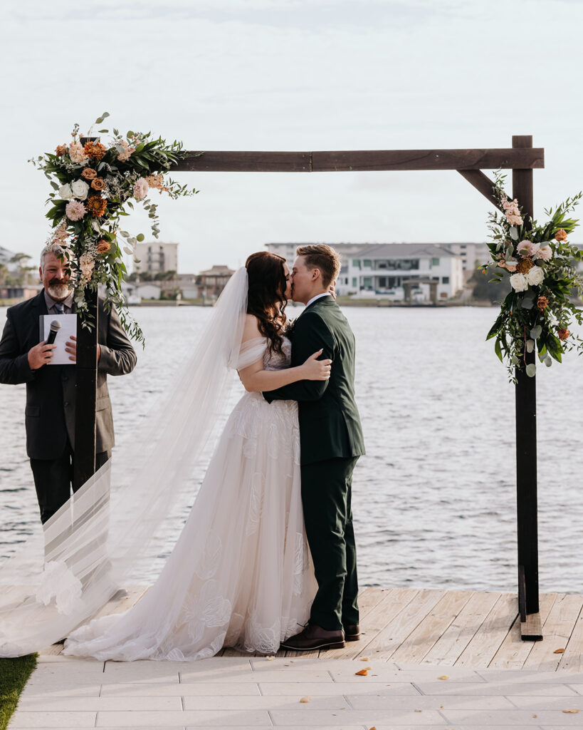 bride and groom share their first kiss