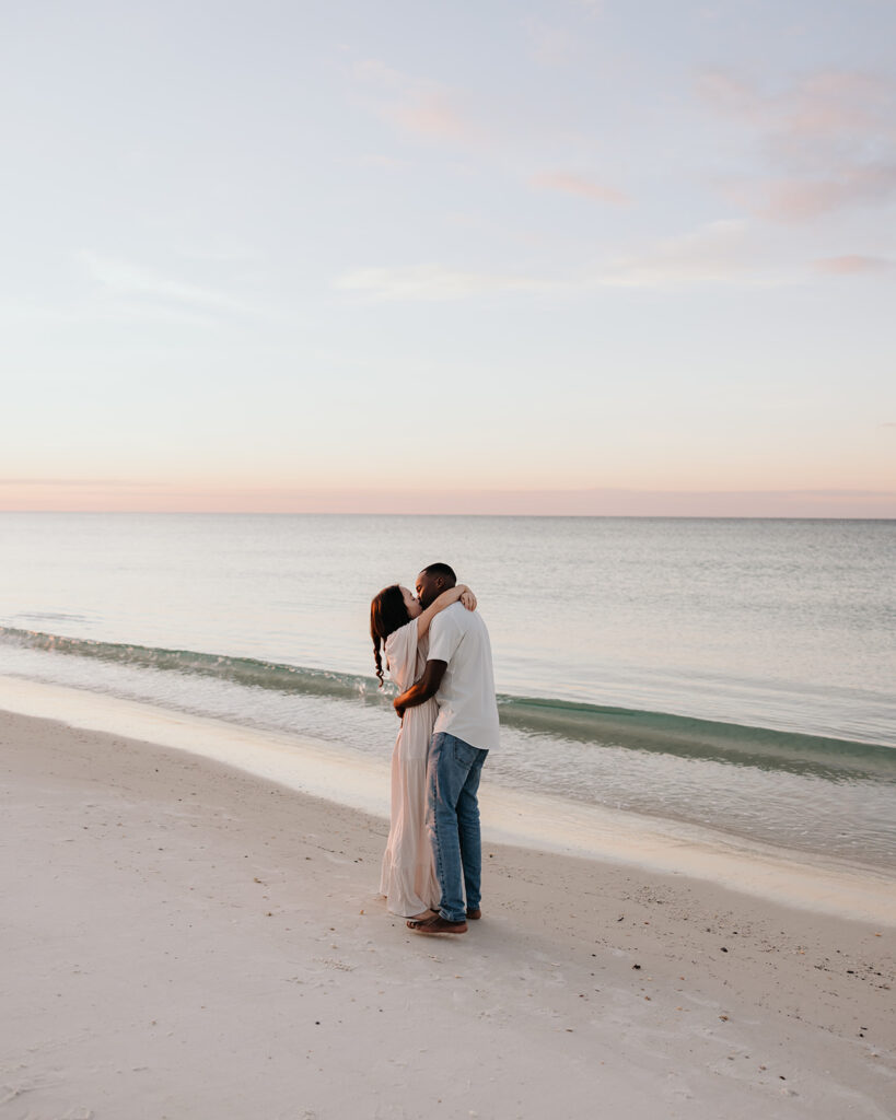 husband and wife dance on the beach of 30A