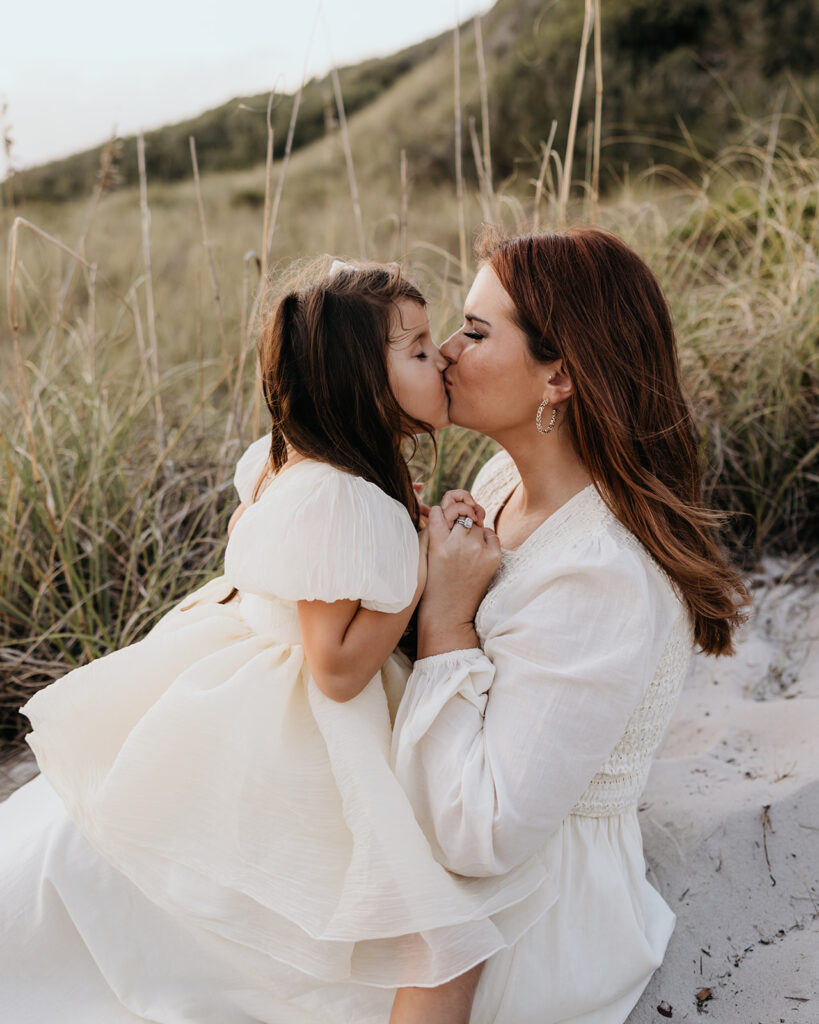 mother kisses her toddler on Pensacola Beach