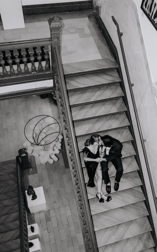bride and groom kiss on the staircase