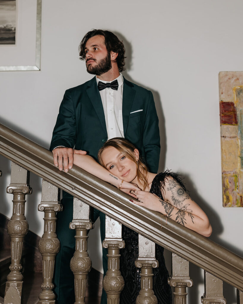man and woman stand on the staircase and pose