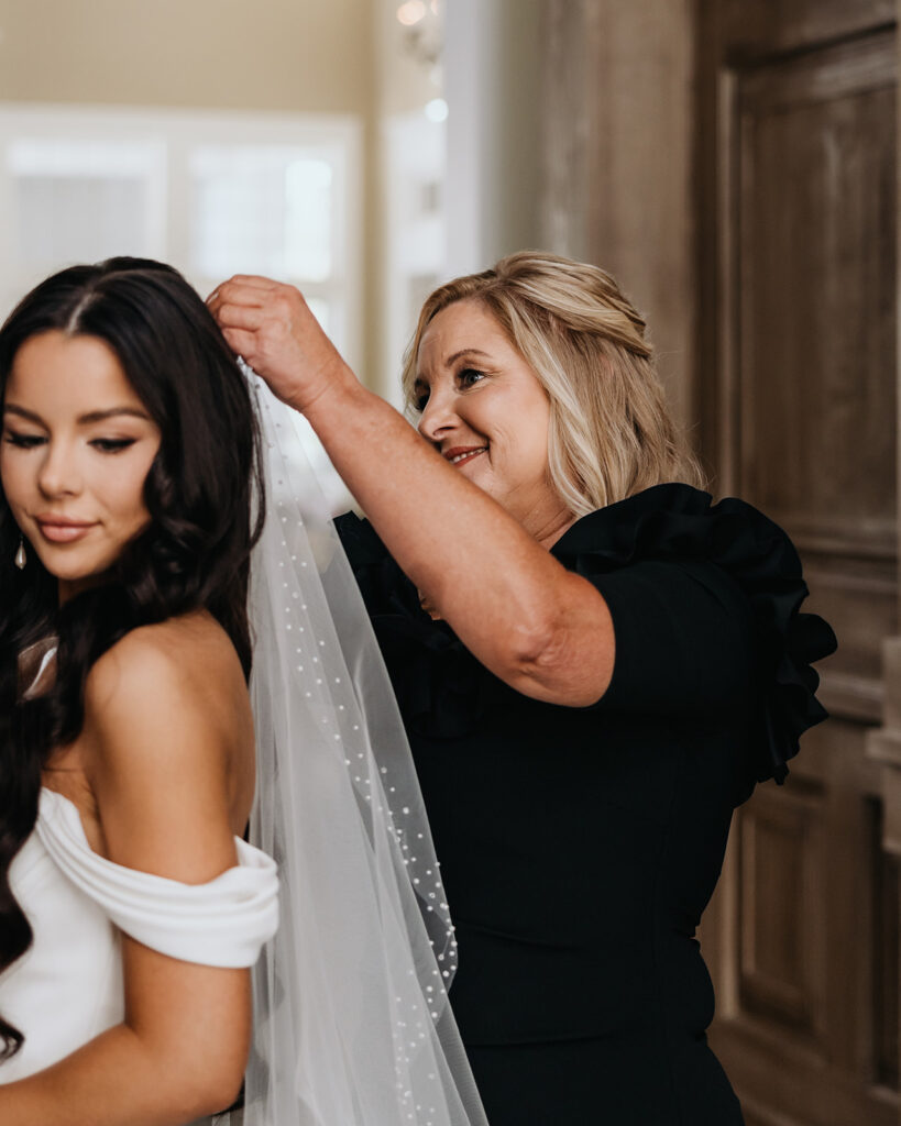 mom puts in bride's veil