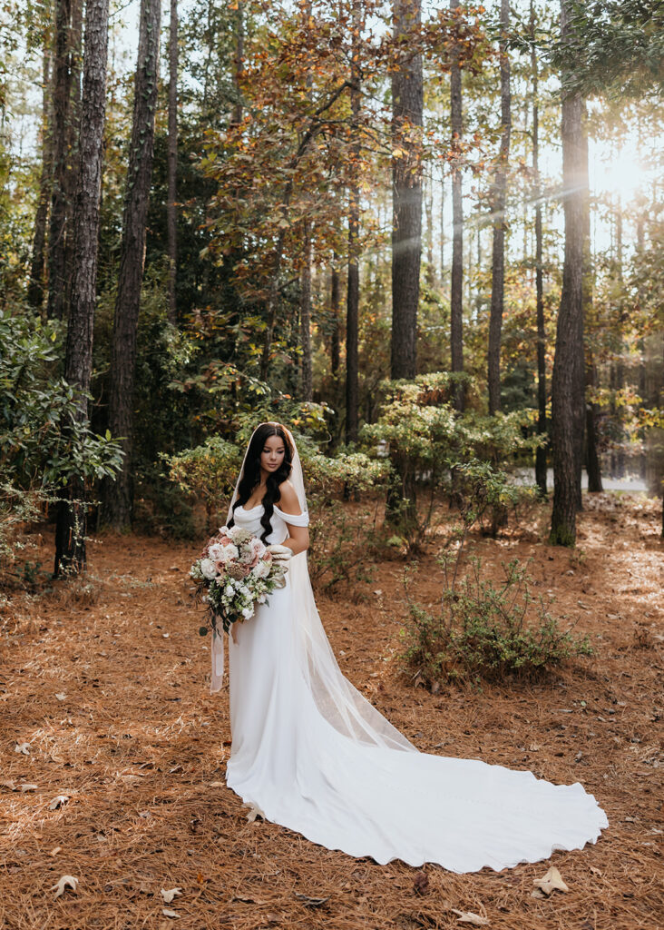 bride poses in the forrest