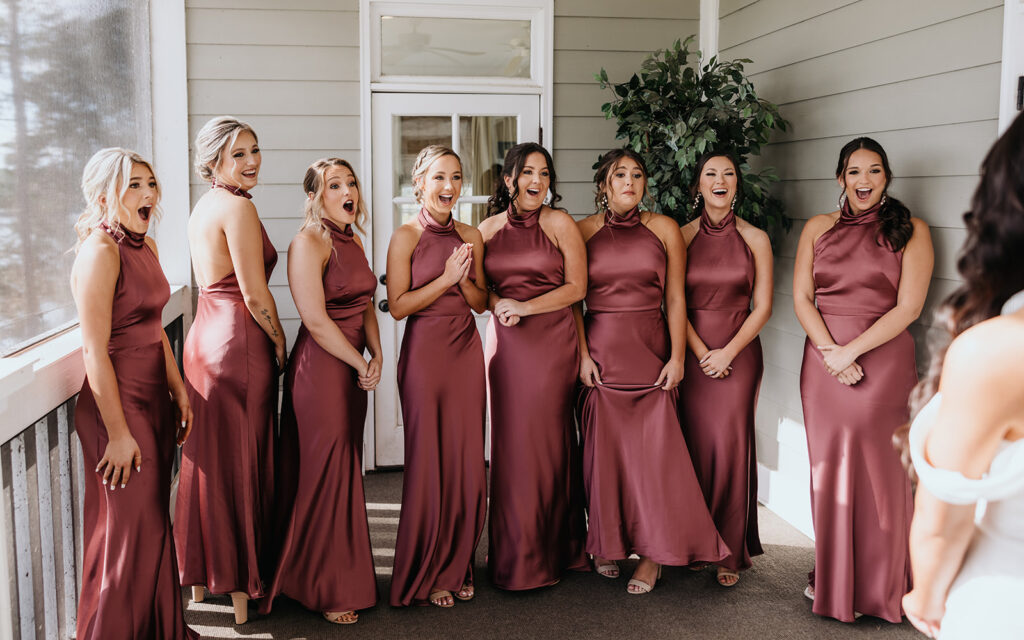 bridesmaids react to seeing the bride in her wedding dress
