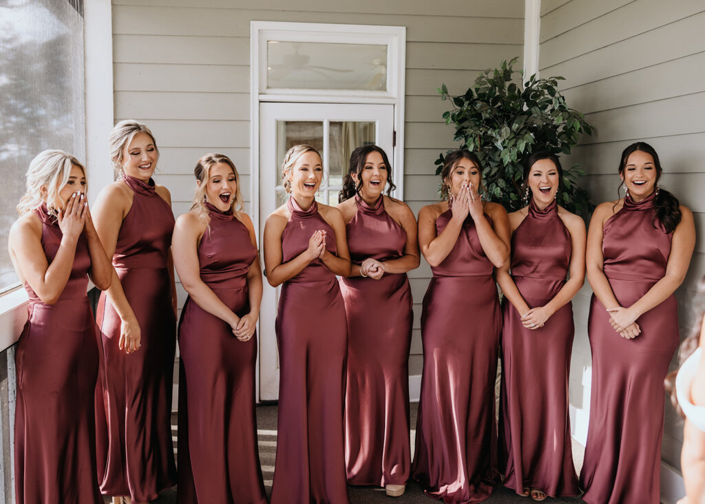 bridesmaids react to seeing the bride in her wedding dress