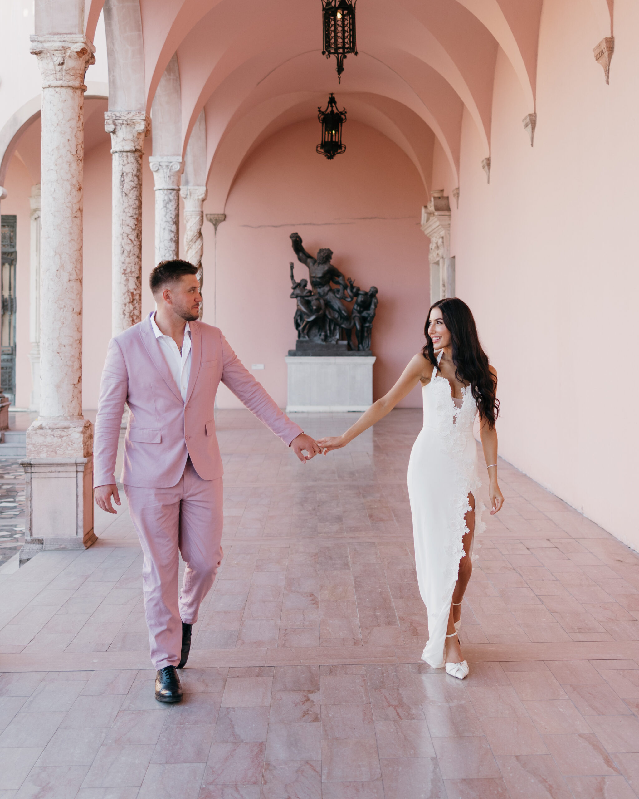 bride and groom walk through The Ringling