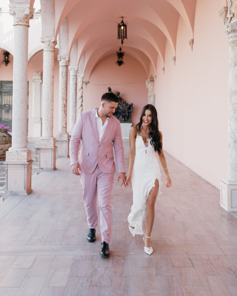 bride and groom walk through the Ringling Art Museum