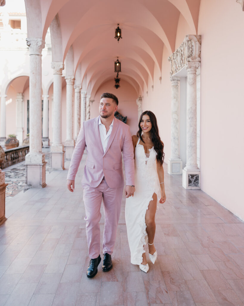 bride and groom walk through the Ringling Art Museum
