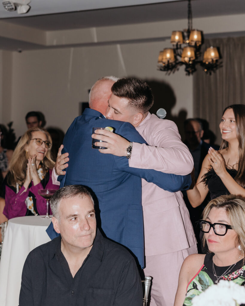 groom hugs his father