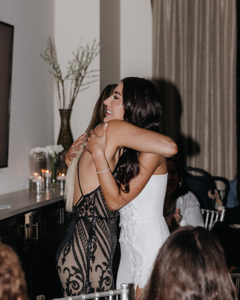 bride hugs bridesmaid
