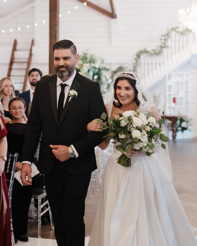 bride and her father walk down the aisle