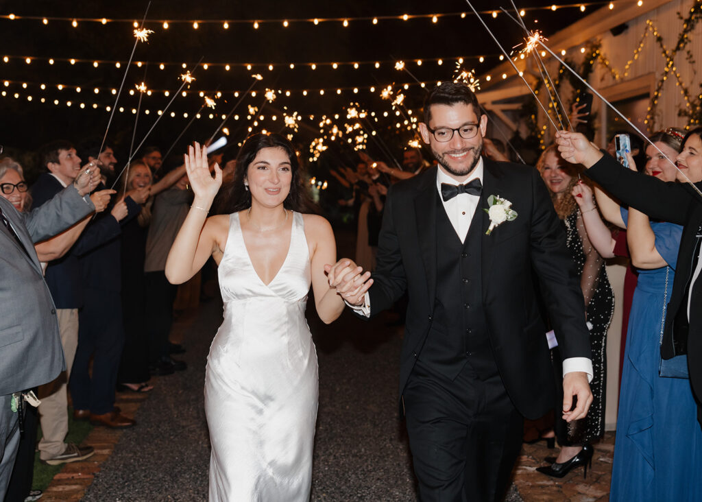 bride and groom exit under sparklers