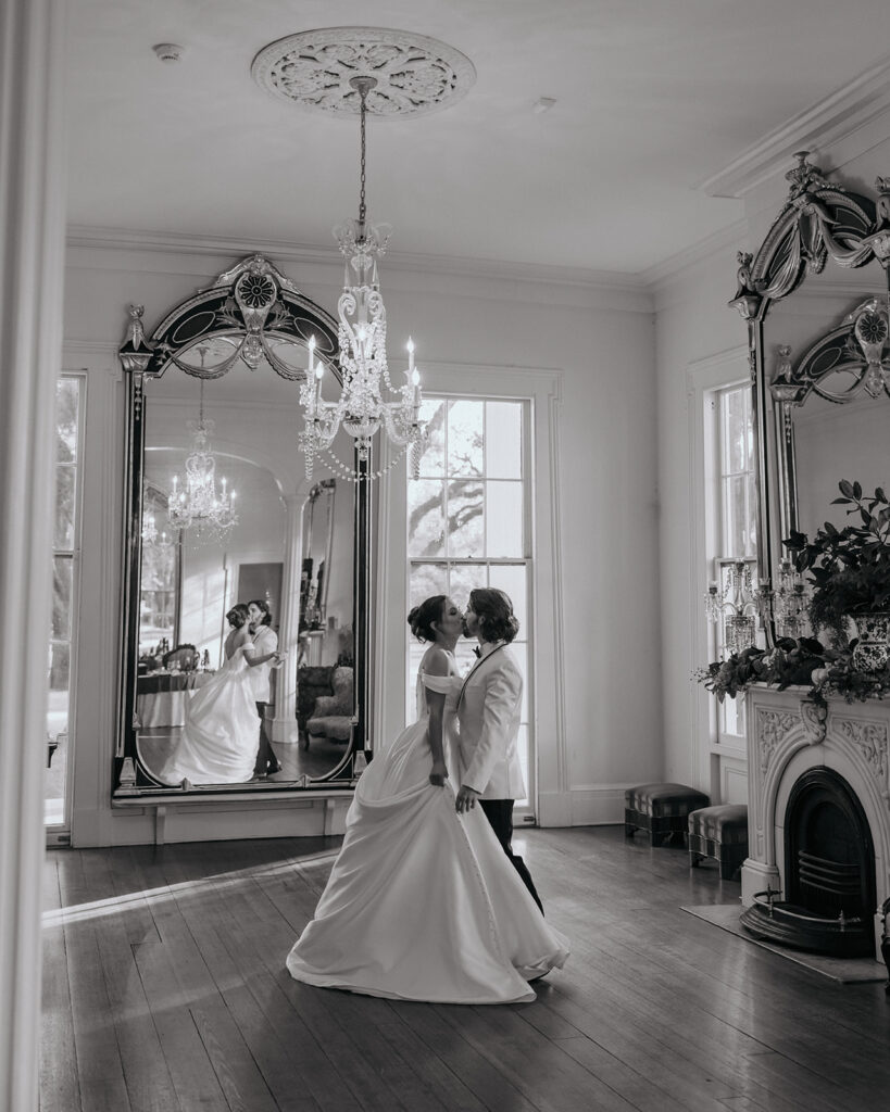bride and groom kiss in a mansion