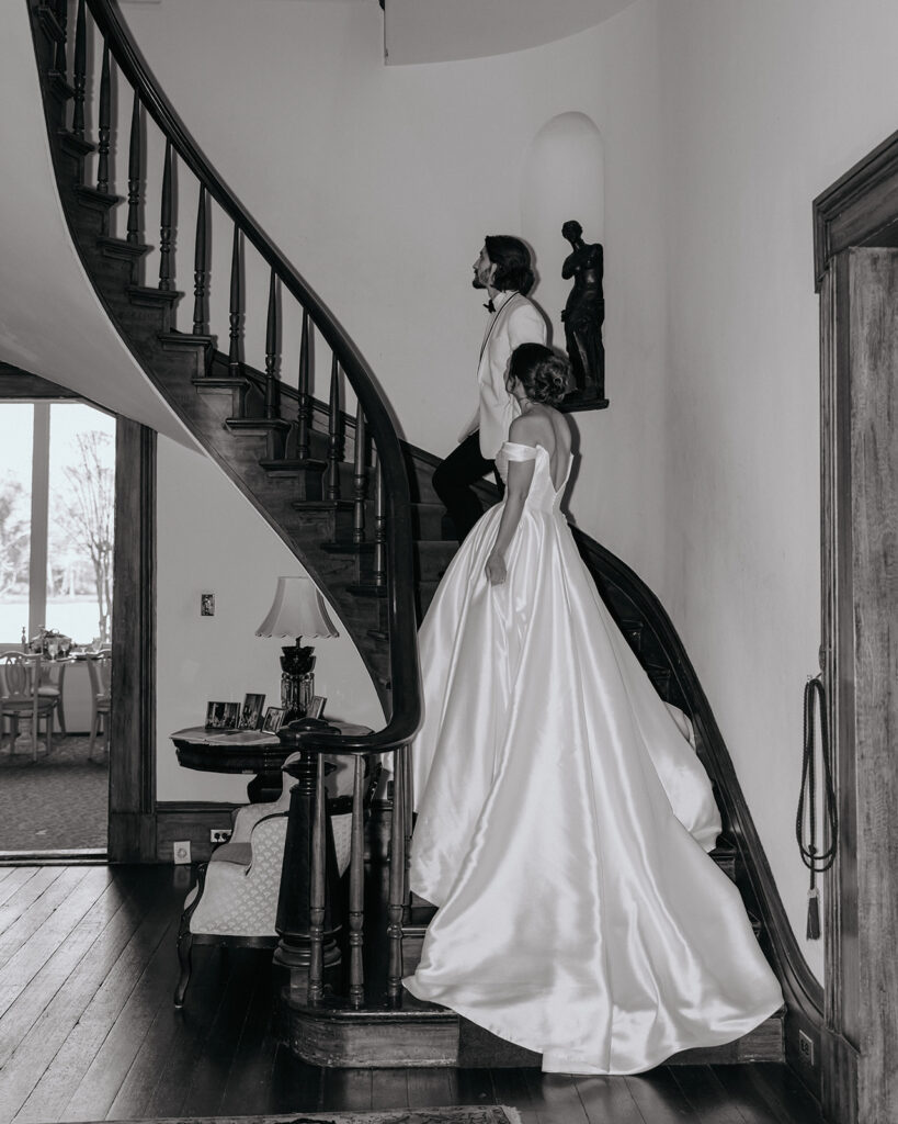 bride and groom walk up the stairs