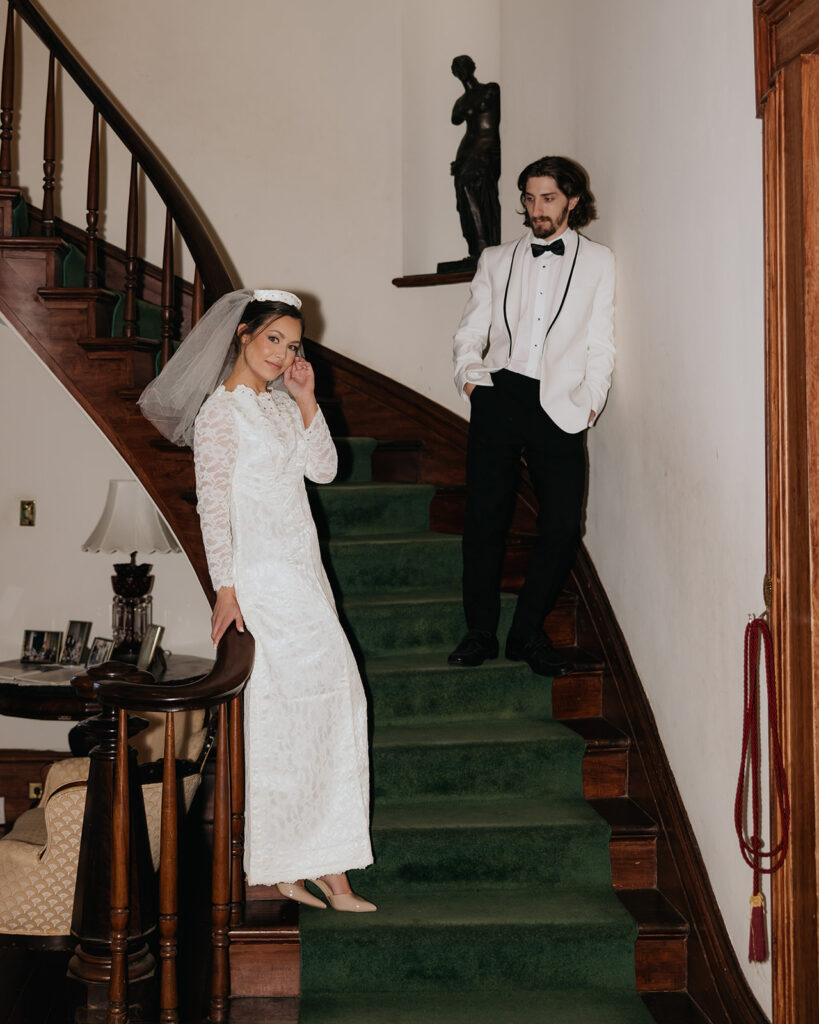 bride and groom pose on a staircase