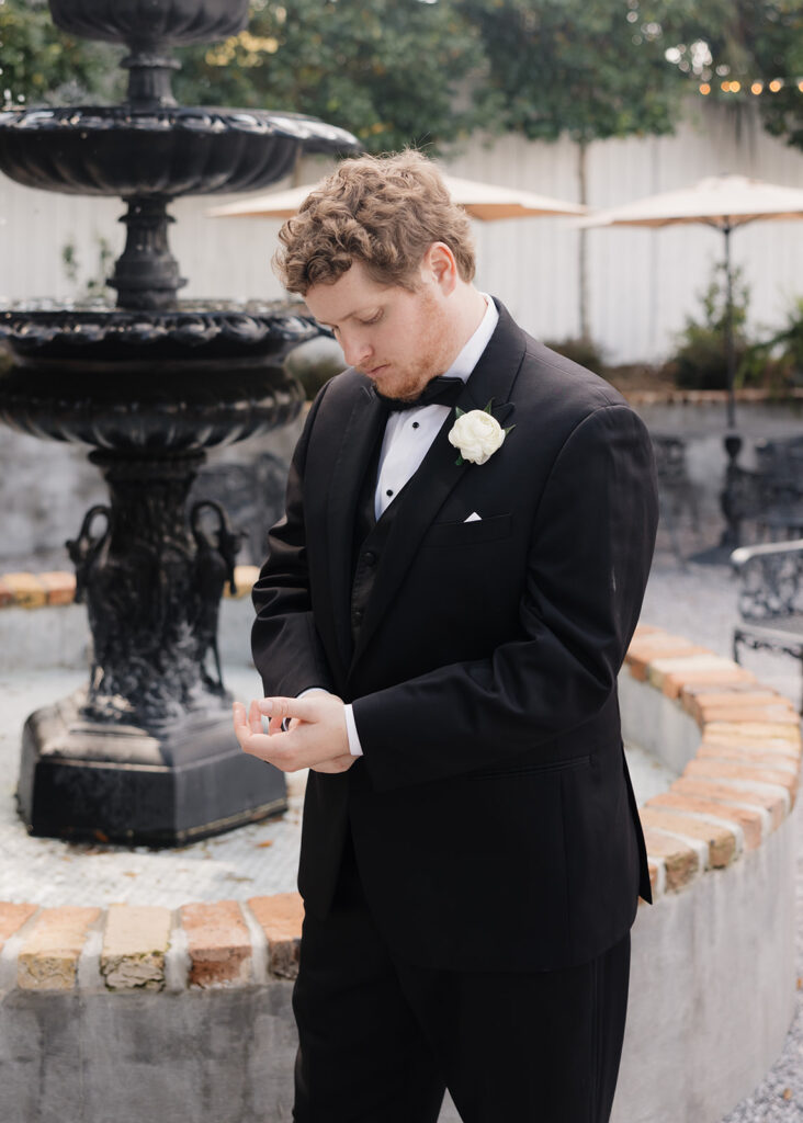 groom adjusts sleeves