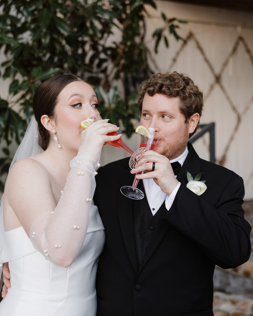 bride and groom share a drink