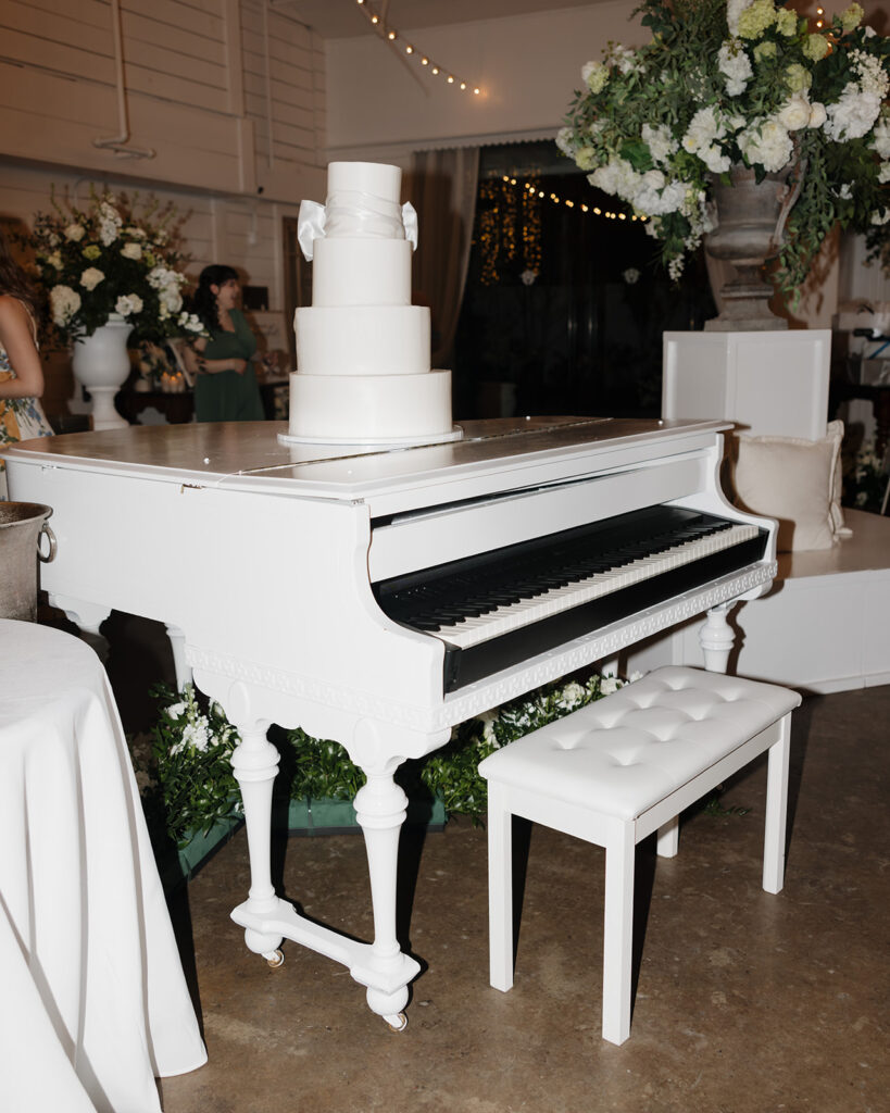 wedding cake sits on a piano