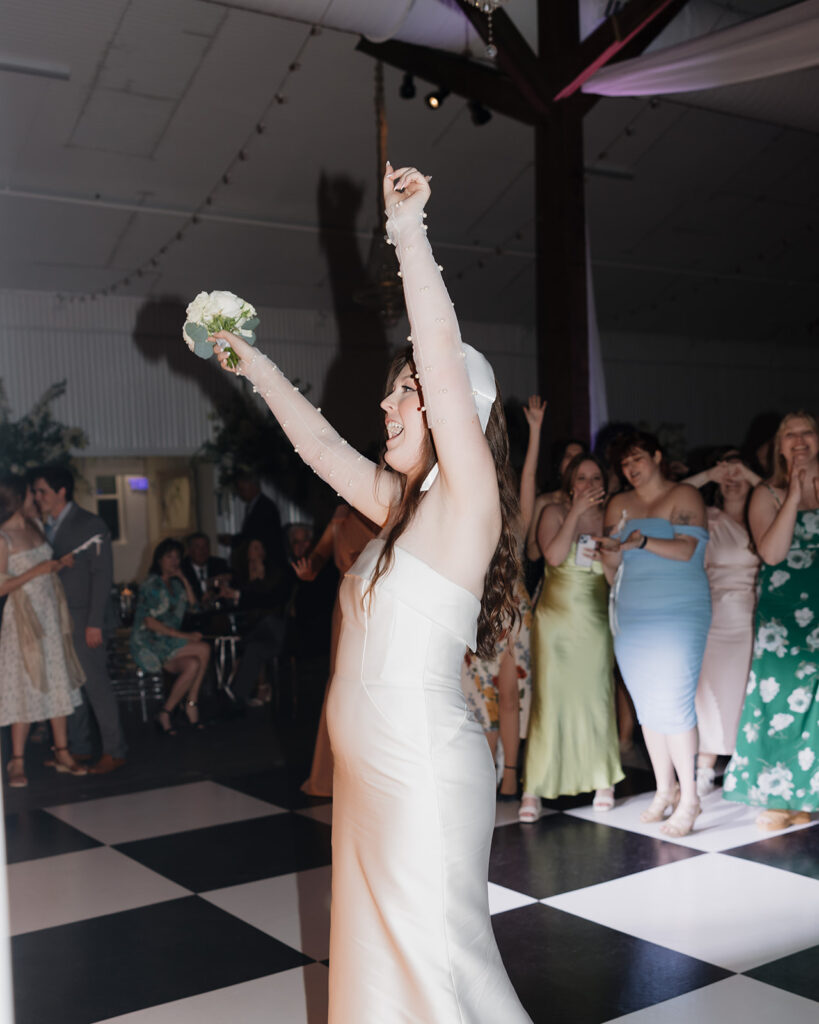 bride throws bouquet