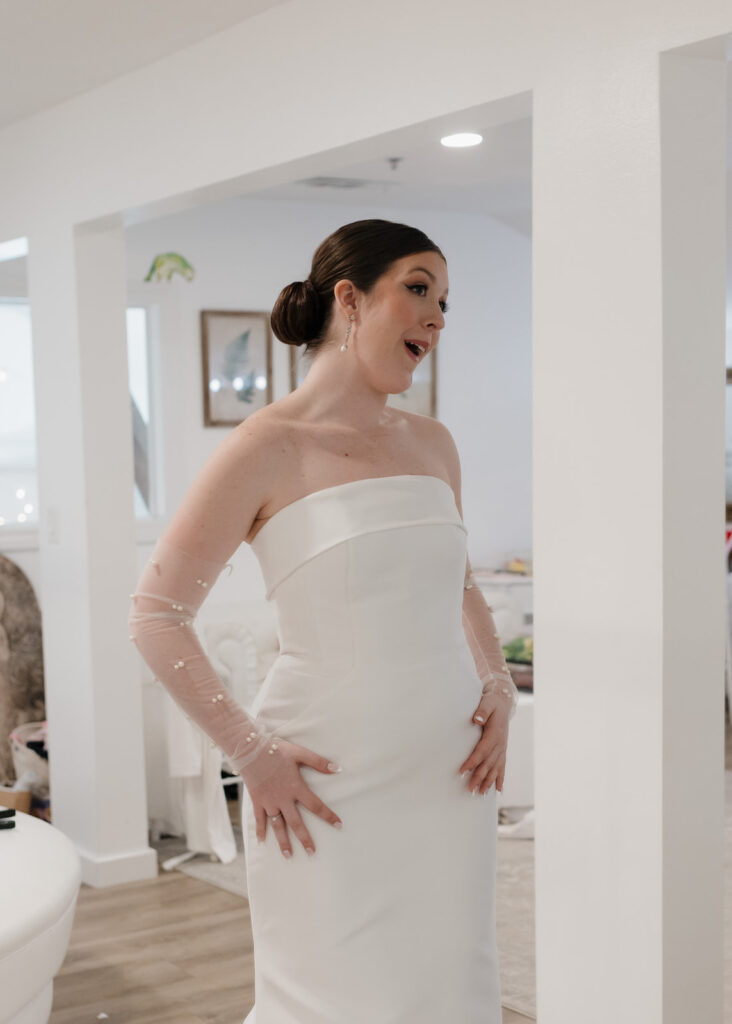 bride reacts to her wedding dress