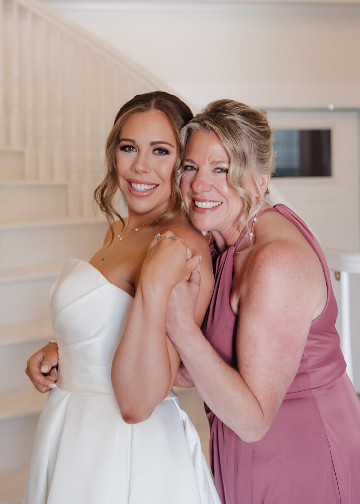 mother of the bride hugs the bride