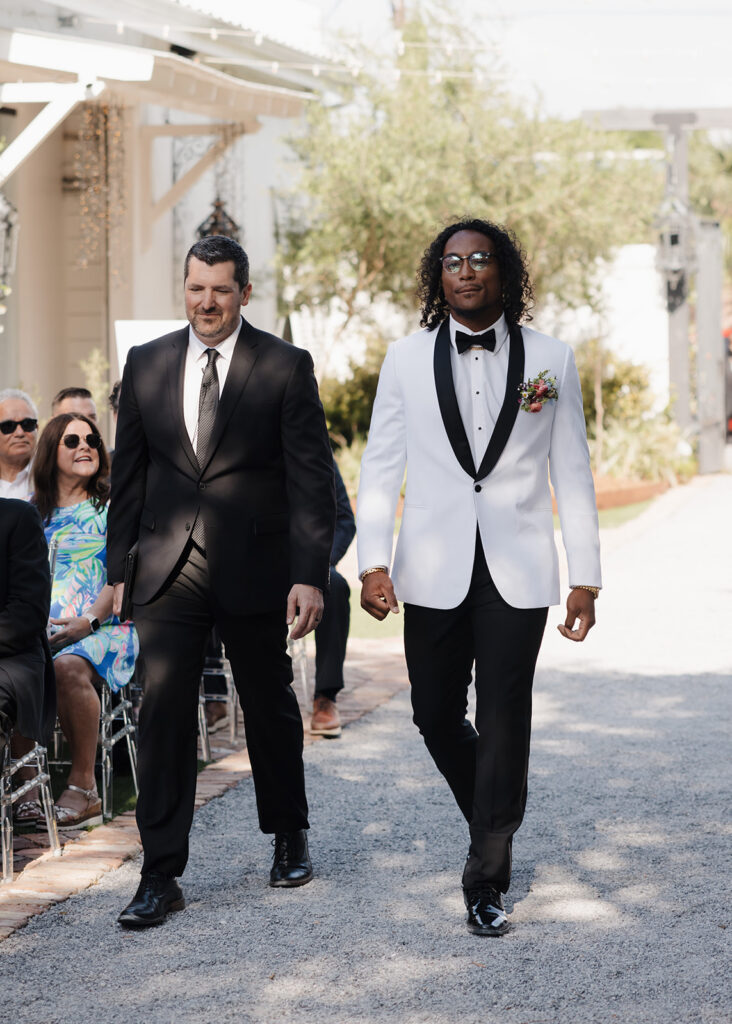 groom and officiant walk down the aisle
