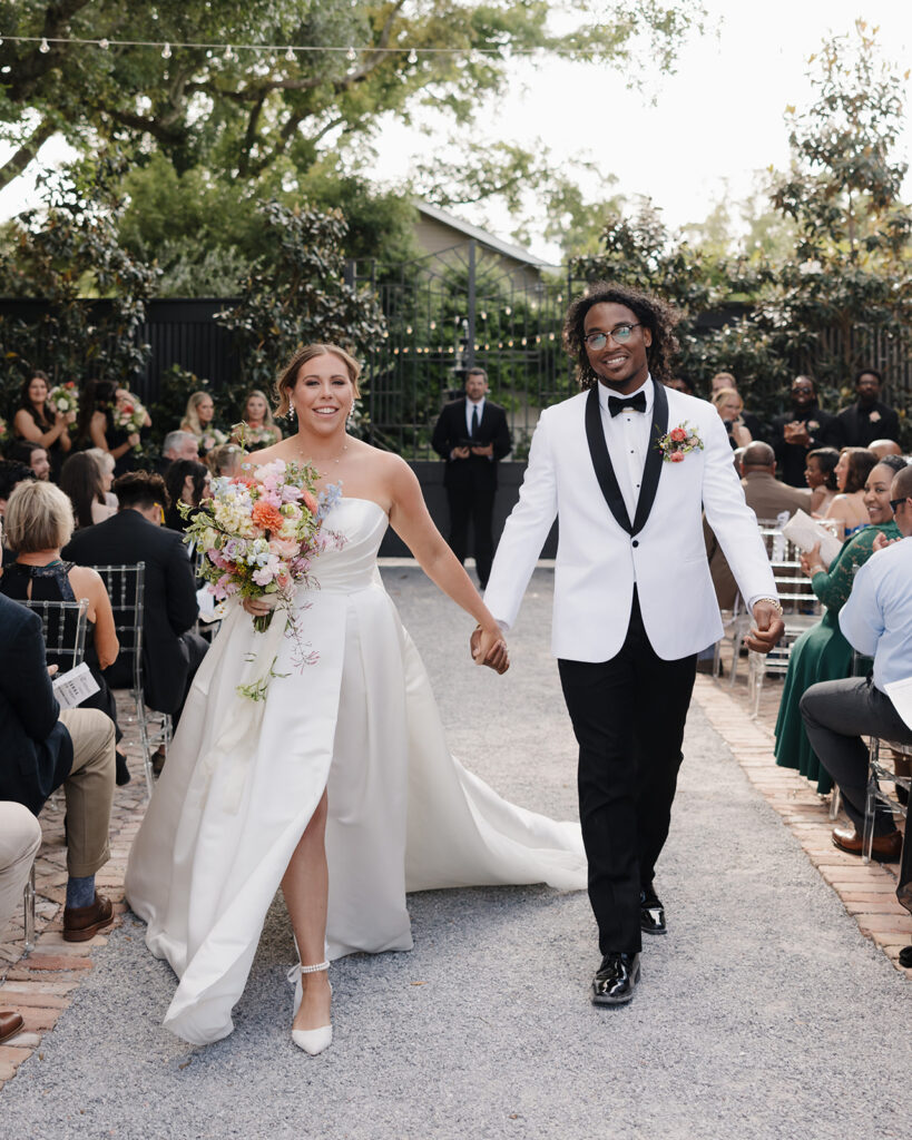 man and woman walk down the aisle