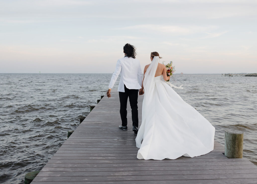 bride and groom walk on a dock in Pensacola Florida