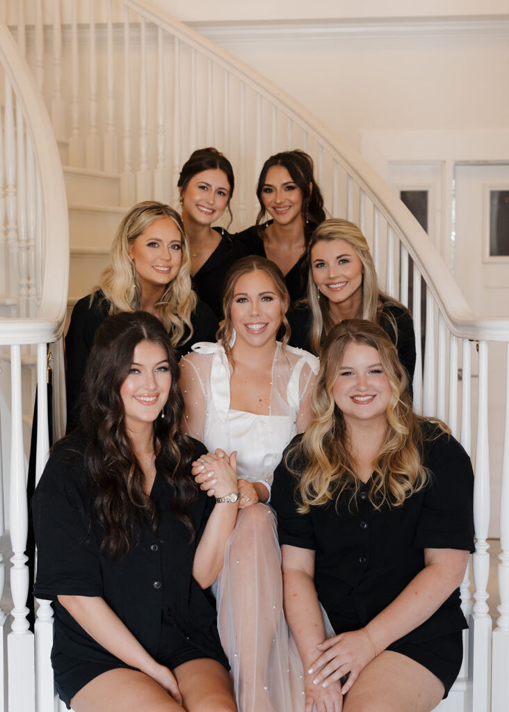 women sit on the staircase of Supposey's bridal suite