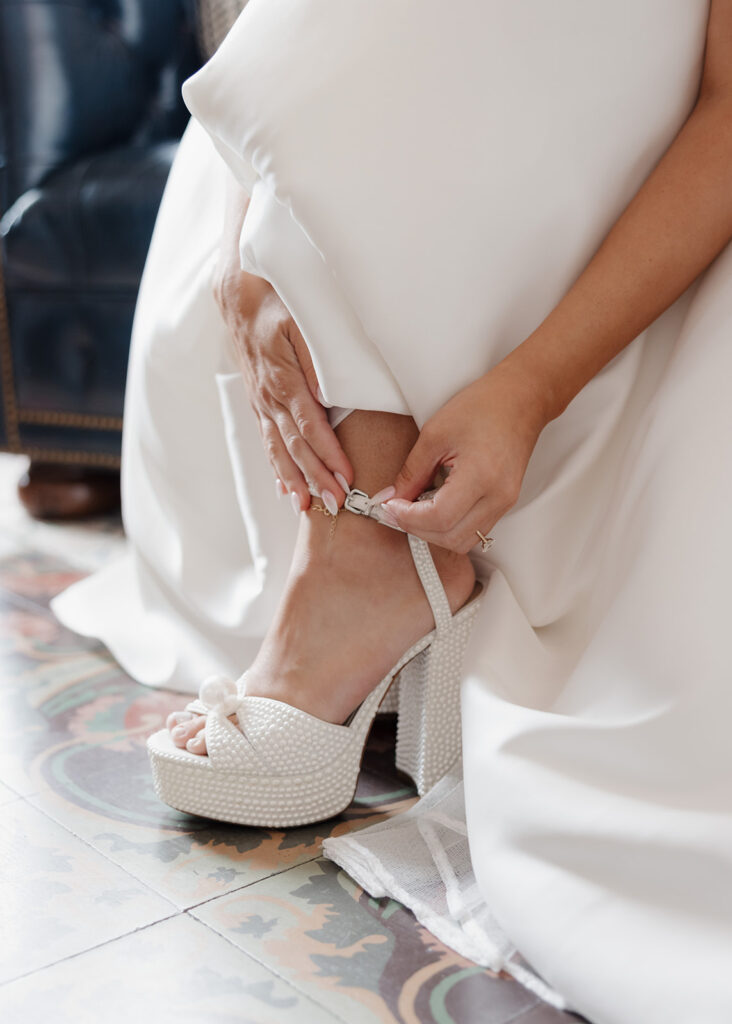 bride puts her heels on