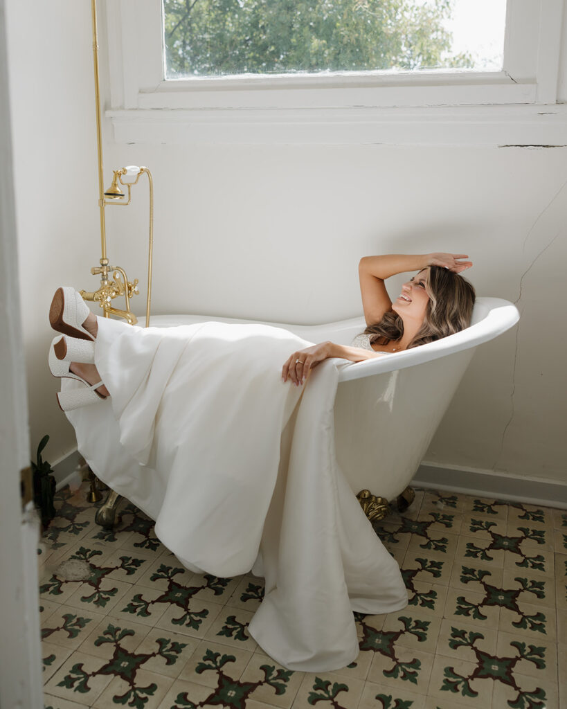 bride sits in a bathtub