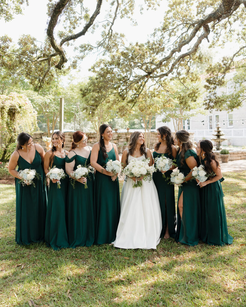 bride and bridesmaids laugh at each other