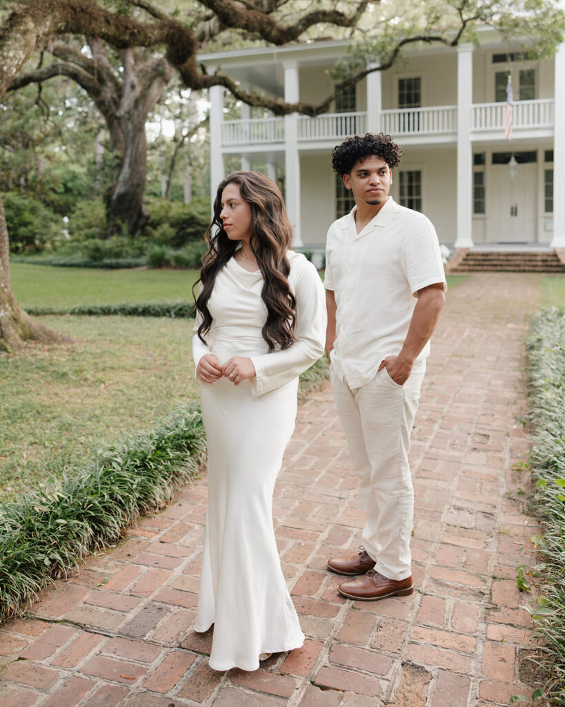 man and woman stand by the Wesley Mansion at the Eden Gardens State Park