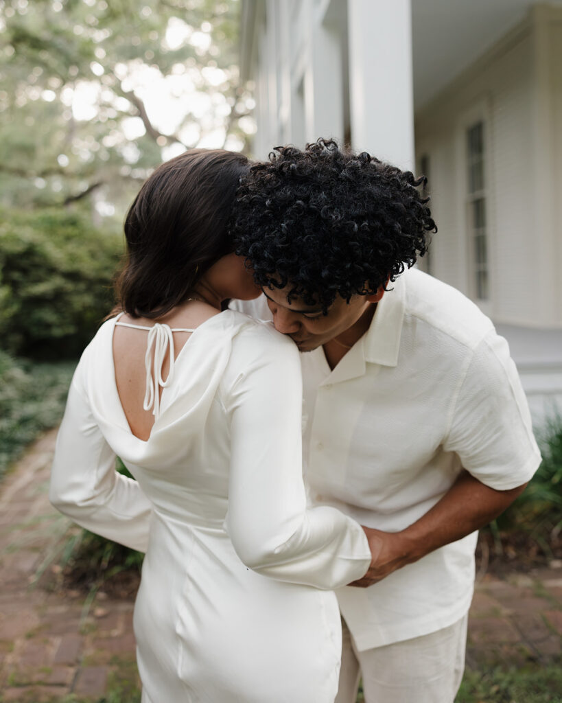 man kisses woman's shoulder