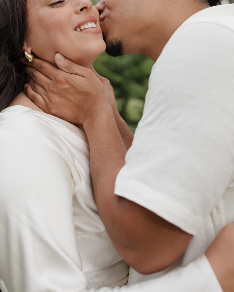 man kisses woman's cheek