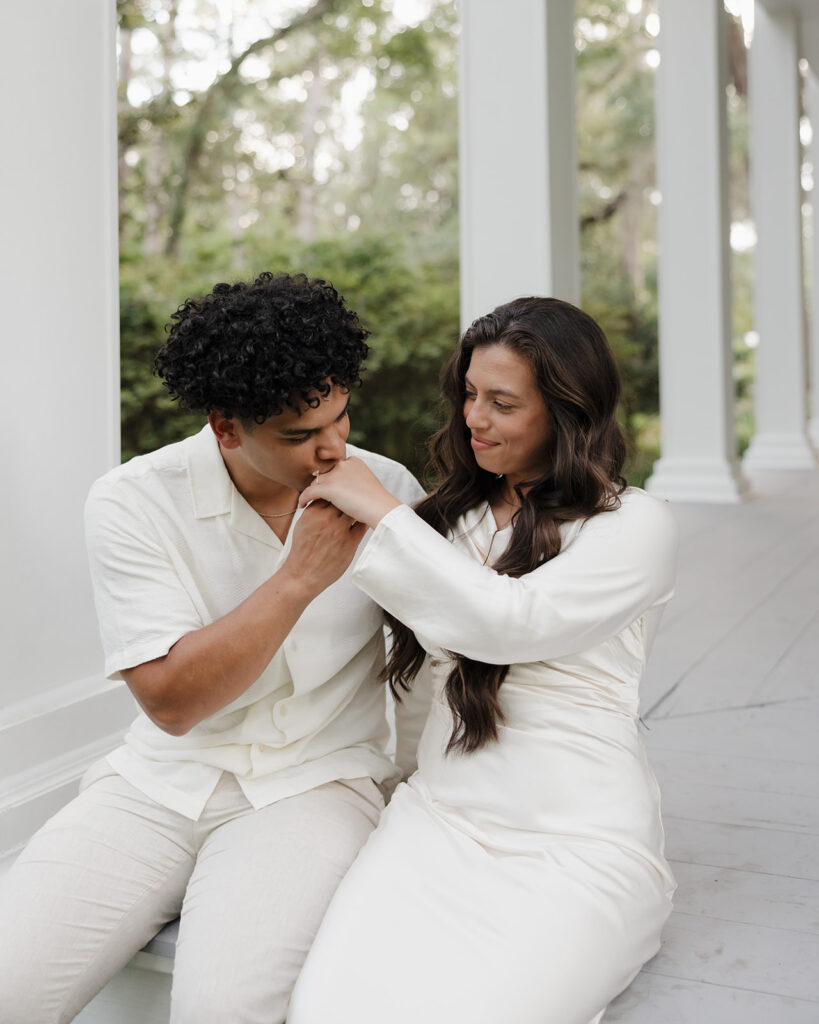 man kisses woman's hand by Eden Gardens State Park