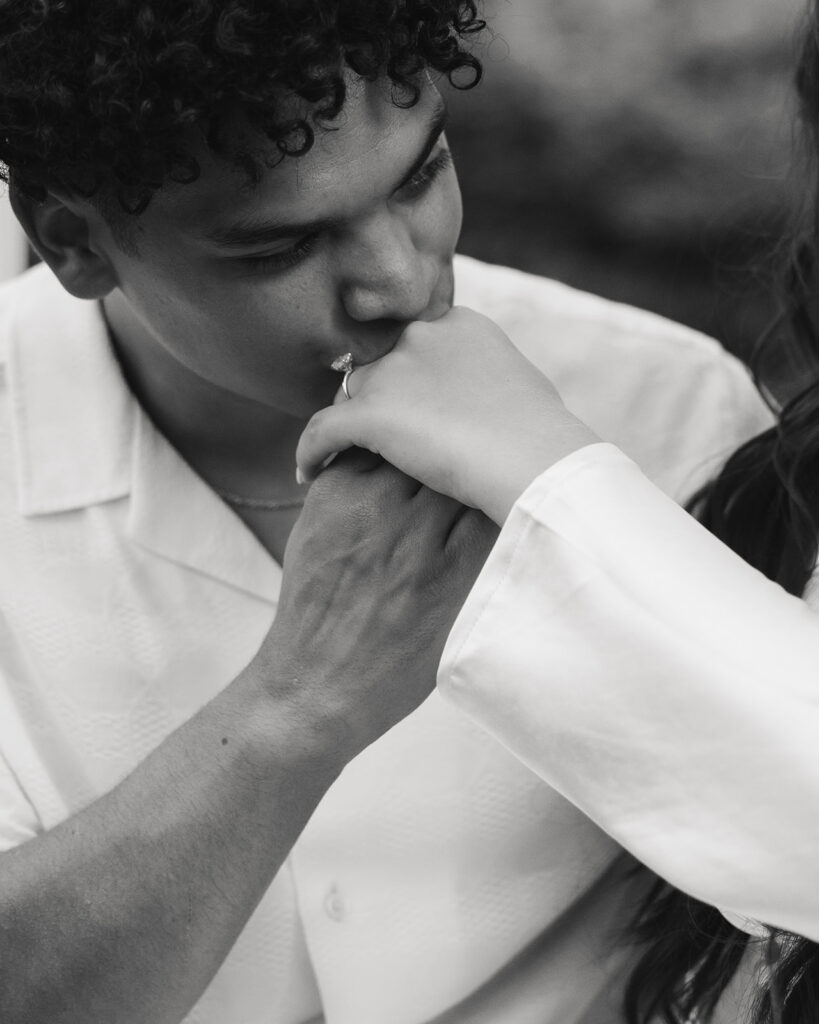 man kisses woman's hand